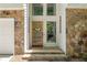 Inviting entryway with stone accents and modern wood door at 110 Fairway Ridge Dr, Johns Creek, GA 30022