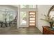 Inviting entryway with modern wood door and view to dining at 110 Fairway Ridge Dr, Johns Creek, GA 30022