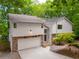 Charming home with stone accents, lush trees, and a spacious garage at 110 Fairway Ridge Dr, Johns Creek, GA 30022