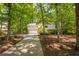 Charming home with stone accents, lush trees, and a long driveway at 110 Fairway Ridge Dr, Johns Creek, GA 30022
