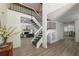 Open foyer features a stairway, black railings, and a view of the living room and kitchen at 110 Fairway Ridge Dr, Johns Creek, GA 30022