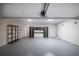 A clean two car garage contains storage cabinets and epoxy flooring at 110 Fairway Ridge Dr, Johns Creek, GA 30022