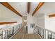 Upstairs hallway with wood beams and railing at 110 Fairway Ridge Dr, Johns Creek, GA 30022