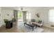 Bright living room featuring a ceiling fan, hardwood floors, and a sliding glass door to the outdoor deck at 110 Fairway Ridge Dr, Johns Creek, GA 30022