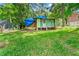 View of the backyard with an old shed covered with a blue tarp at 2180 Rexford Dr, Decatur, GA 30034