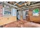 Sunroom with peeling brick and yellow paint and multiple windows at 2180 Rexford Dr, Decatur, GA 30034