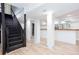 View of the finished basement featuring plank flooring, columns, a bar, and stairs at 3193 Trasher Cir, Decatur, GA 30032