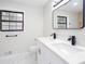 Bright bathroom with a double vanity, modern fixtures, and a large mirror offering a clean, contemporary aesthetic at 3193 Trasher Cir, Decatur, GA 30032