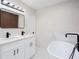 Well-lit bathroom featuring modern fixtures, a freestanding tub, a double vanity, and elegant marble accents at 3193 Trasher Cir, Decatur, GA 30032