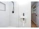 A modern and sleek bathroom features white tiling, a glass shower stall, and a small floating sink at 3193 Trasher Cir, Decatur, GA 30032