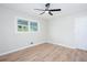 Light, bright bedroom with fresh paint, new floors, ceiling fan, and a window with a backyard view at 3193 Trasher Cir, Decatur, GA 30032
