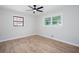 Bright bedroom with new laminate flooring, fresh paint, ceiling fan, and natural light from two windows at 3193 Trasher Cir, Decatur, GA 30032