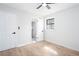 A modern bedroom featuring two doors, a window, and light hardwood floors at 3193 Trasher Cir, Decatur, GA 30032