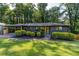 A charming single-story home offers a covered carport, fresh landscaping, and a lush green lawn at 3193 Trasher Cir, Decatur, GA 30032