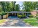A ranch-style home features a covered carport, manicured landscaping, and a freshly painted front exterior at 3193 Trasher Cir, Decatur, GA 30032