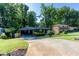 A charming single-story home boasts a covered carport, healthy landscaping, and a green front yard at 3193 Trasher Cir, Decatur, GA 30032