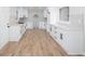 Newly renovated kitchen with white cabinets, quartz countertops, stainless vent, and new flooring at 3193 Trasher Cir, Decatur, GA 30032