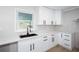 Contemporary kitchen features white cabinets, quartz countertops, and black modern fixtures at 3193 Trasher Cir, Decatur, GA 30032