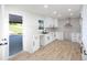 Renovated kitchen with white cabinetry, quartz countertops, and stainless steel exhaust hood at 3193 Trasher Cir, Decatur, GA 30032