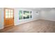 Bright living room features hardwood floors, a large window, and a wooden front door at 3193 Trasher Cir, Decatur, GA 30032