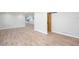Open living room view, showcasing new flooring and an opening to a modern, renovated kitchen at 3193 Trasher Cir, Decatur, GA 30032