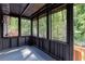 View of screened in porch overlooking backyard, featuring wood deck and dark painted walls at 3193 Trasher Cir, Decatur, GA 30032