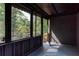 View of screened in porch overlooking backyard, featuring wood deck and brick walls at 3193 Trasher Cir, Decatur, GA 30032
