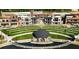 Aerial view showcasing community green space, amphitheater, and mixed-use buildings at 4815 Ramblewood Dr, Cumming, GA 30028