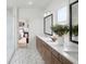 Bright bathroom with dual sink vanity, wood cabinets, and a view to the main bedroom through an open doorway at 4815 Ramblewood Dr, Cumming, GA 30028