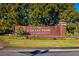Welcome to The Collection at Forsyth, a beautifully landscaped community entrance with a brick sign and vibrant flowers at 4815 Ramblewood Dr, Cumming, GA 30028