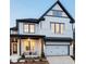 Charming two-story home featuring a modern farmhouse design with a two-car garage and inviting front porch at 4815 Ramblewood Dr, Cumming, GA 30028