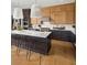 Stylish kitchen with an island and seating, stainless steel appliances, and wood cabinets at 4815 Ramblewood Dr, Cumming, GA 30028