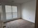 Bedroom featuring light walls, a window, and carpeted floors at 95 Revere Dr, Fairburn, GA 30213