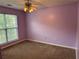 Bedroom featuring a window, ceiling fan, and carpeted floors at 95 Revere Dr, Fairburn, GA 30213
