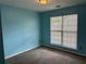 Bedroom featuring light-blue walls, a window, and carpeted floors at 95 Revere Dr, Fairburn, GA 30213
