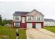 Charming two-story home features a well-manicured lawn, two car garage, and traditional architectural style at 95 Revere Dr, Fairburn, GA 30213