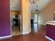 Open living area with wood floors connecting to kitchen with stainless appliances at 95 Revere Dr, Fairburn, GA 30213