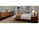 Charming bedroom with hardwood floors, natural light, closet, workspace, and stylish mid-century modern furniture at 1100 Welch Sw St, Atlanta, GA 30310