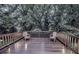 Outdoor deck with lounge chairs, stylish wooden railings, and a backdrop of tall trees for ultimate privacy at 1100 Welch Sw St, Atlanta, GA 30310