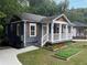 Inviting home with a covered front porch, garden, and a freshly poured concrete driveway at 1100 Welch Sw St, Atlanta, GA 30310