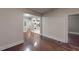 Hallway featuring hardwood floors with laundry hookup and a partial view of the kitchen at 1100 Welch Sw St, Atlanta, GA 30310