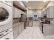 Modern kitchen features gray cabinets, stainless appliances, granite countertops, and tile floors at 1100 Welch Sw St, Atlanta, GA 30310