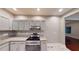 Well-lit kitchen with granite countertops, stainless steel appliances, and ample gray cabinet space at 1100 Welch Sw St, Atlanta, GA 30310