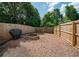 Fenced backyard featuring a mulched area and brick fire pit, offering privacy at 1507 Paces Ferry North Se, Smyrna, GA 30080