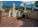 Fenced backyard featuring a mulched area, brick fire pit, and partial view of neighboring homes at 1507 Paces Ferry North Se, Smyrna, GA 30080