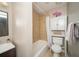 Cozy bathroom with tiled shower over tub, vanity and added storage at 1507 Paces Ferry North Se, Smyrna, GA 30080
