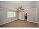 Neutral bedroom with a ceiling fan, plush carpeting, and a bright window at 1507 Paces Ferry North Se, Smyrna, GA 30080