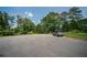 Wide driveway surrounded by green trees leading to the home at 1507 Paces Ferry North Se, Smyrna, GA 30080