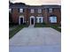 Traditional brick townhouse with a well-maintained front yard and private driveway at 1507 Paces Ferry North Se, Smyrna, GA 30080