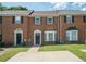 Traditional brick townhouse with a well-maintained front yard and private driveway at 1507 Paces Ferry North Se, Smyrna, GA 30080